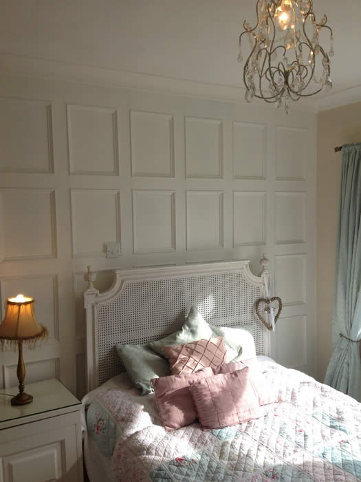 bedroom beaded panelling acorn cottage south wales with french bed